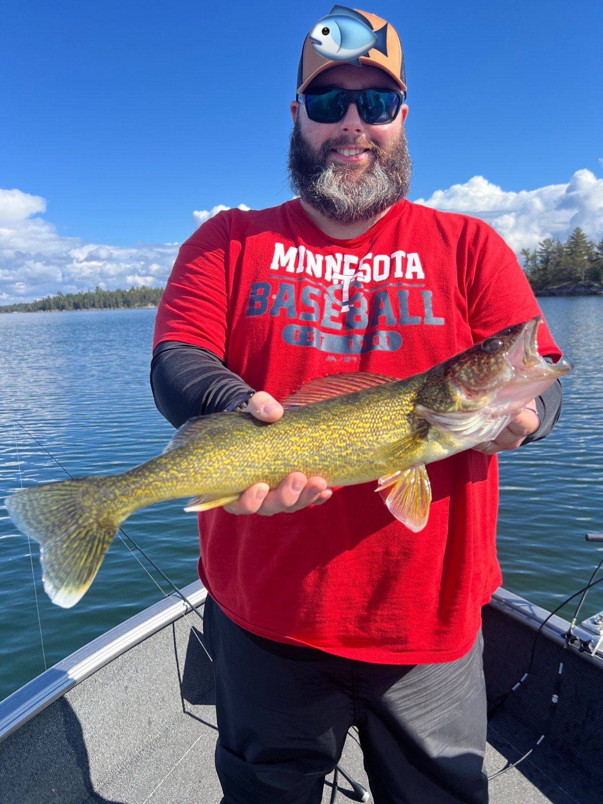 David out on the lake holding a walleye
